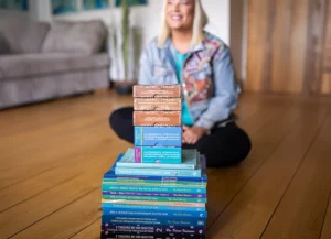 Dr Karen Treisman sitting behind her books and cards