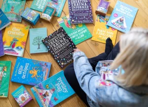 Dr Karen Treisman sitting with a selection of her books